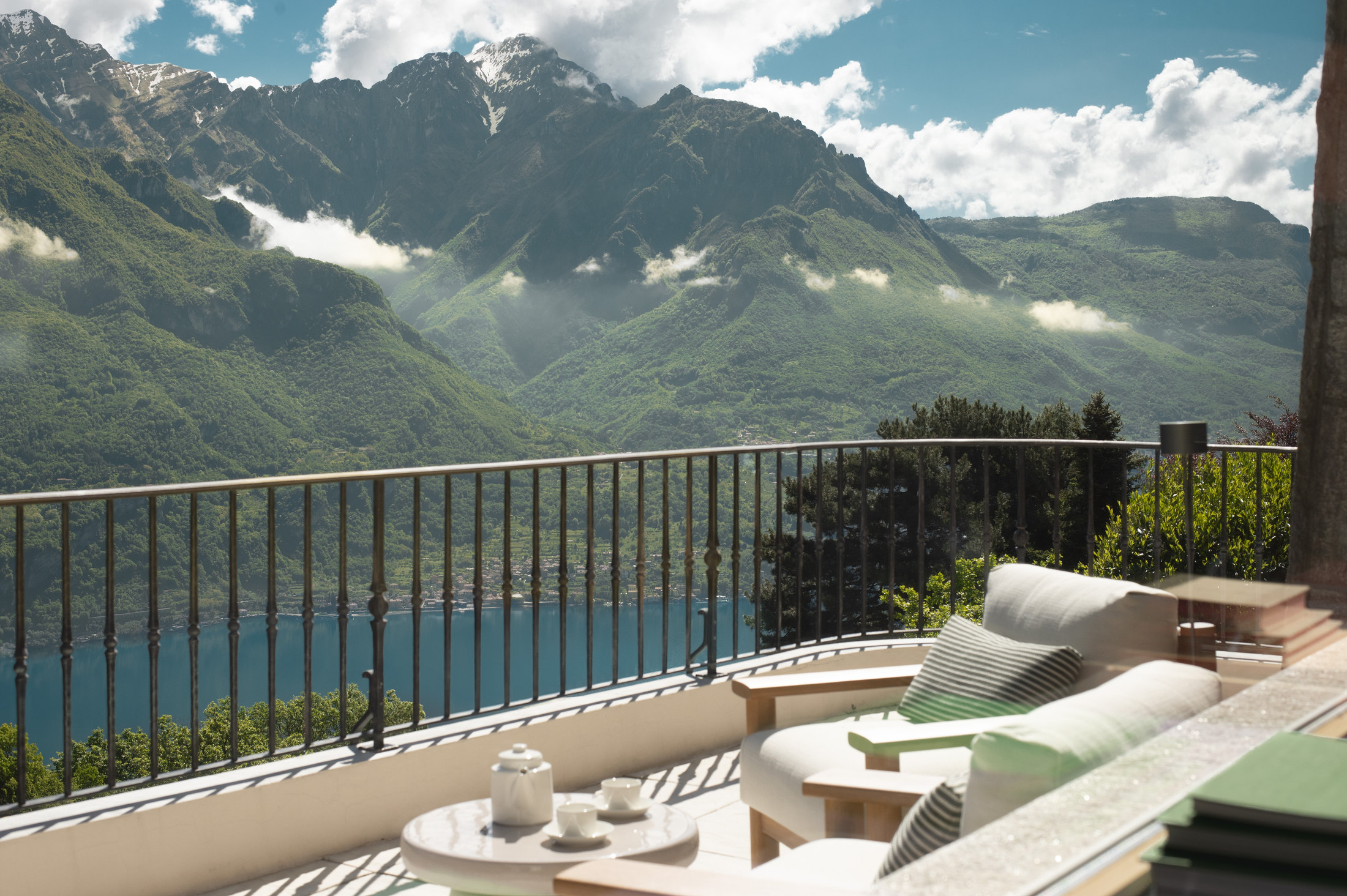 Terrace with lounge seating overlooking Lake Como and the mountains