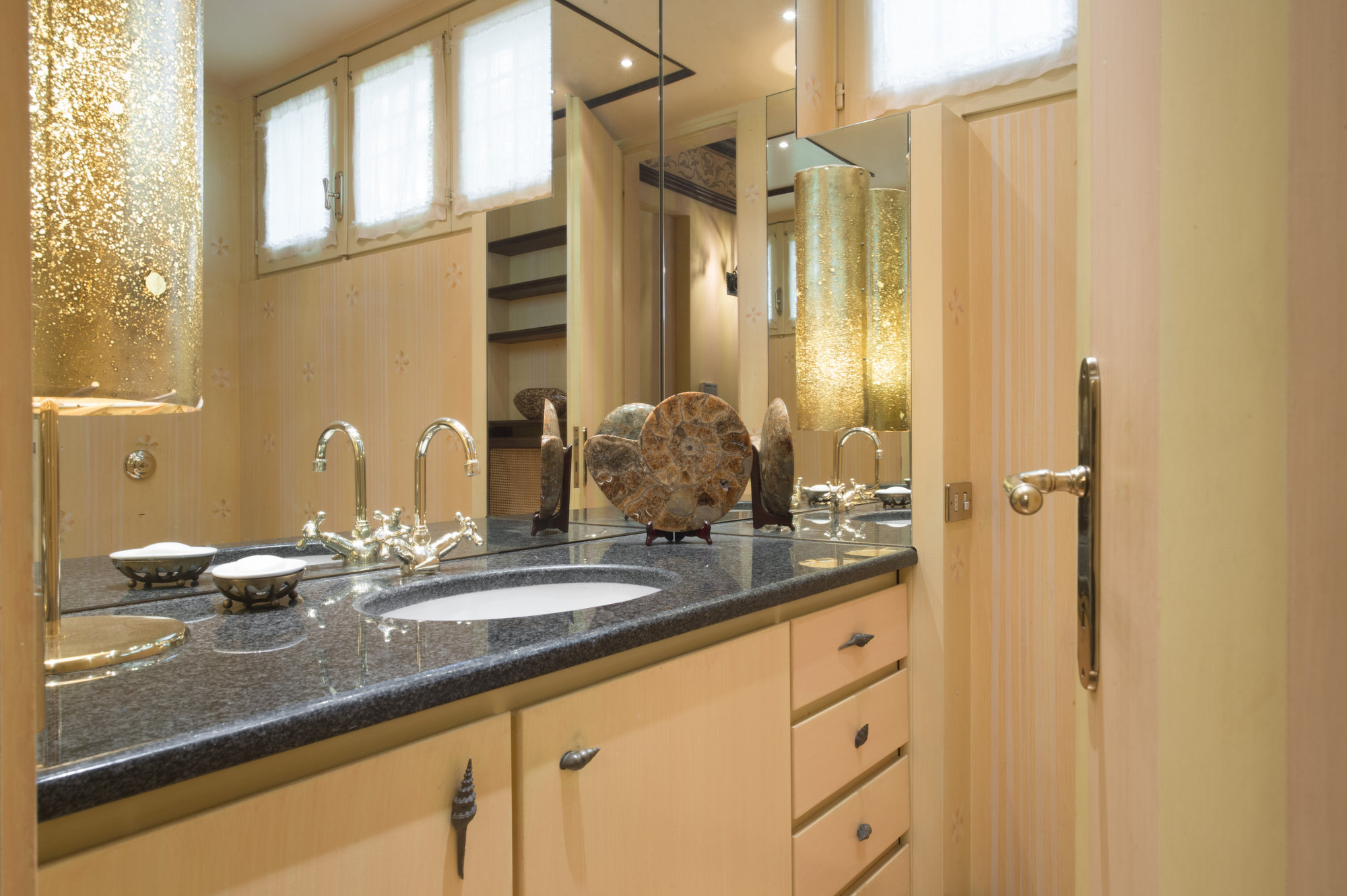 Light-wood bathroom with ammonite detail