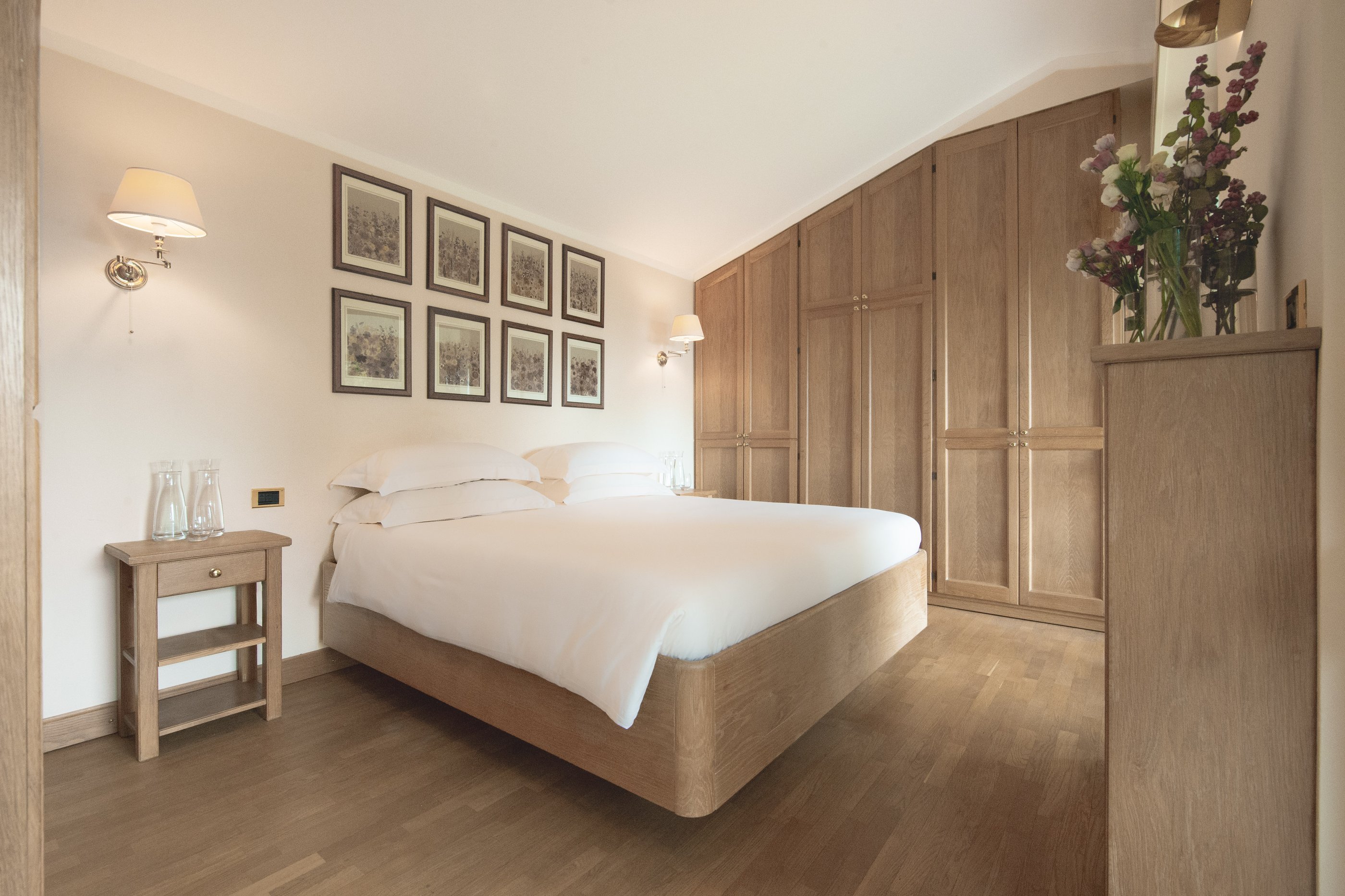 Double bedroom with oak wardrobes beneath a sloping ceiling, first floor of the Guest House