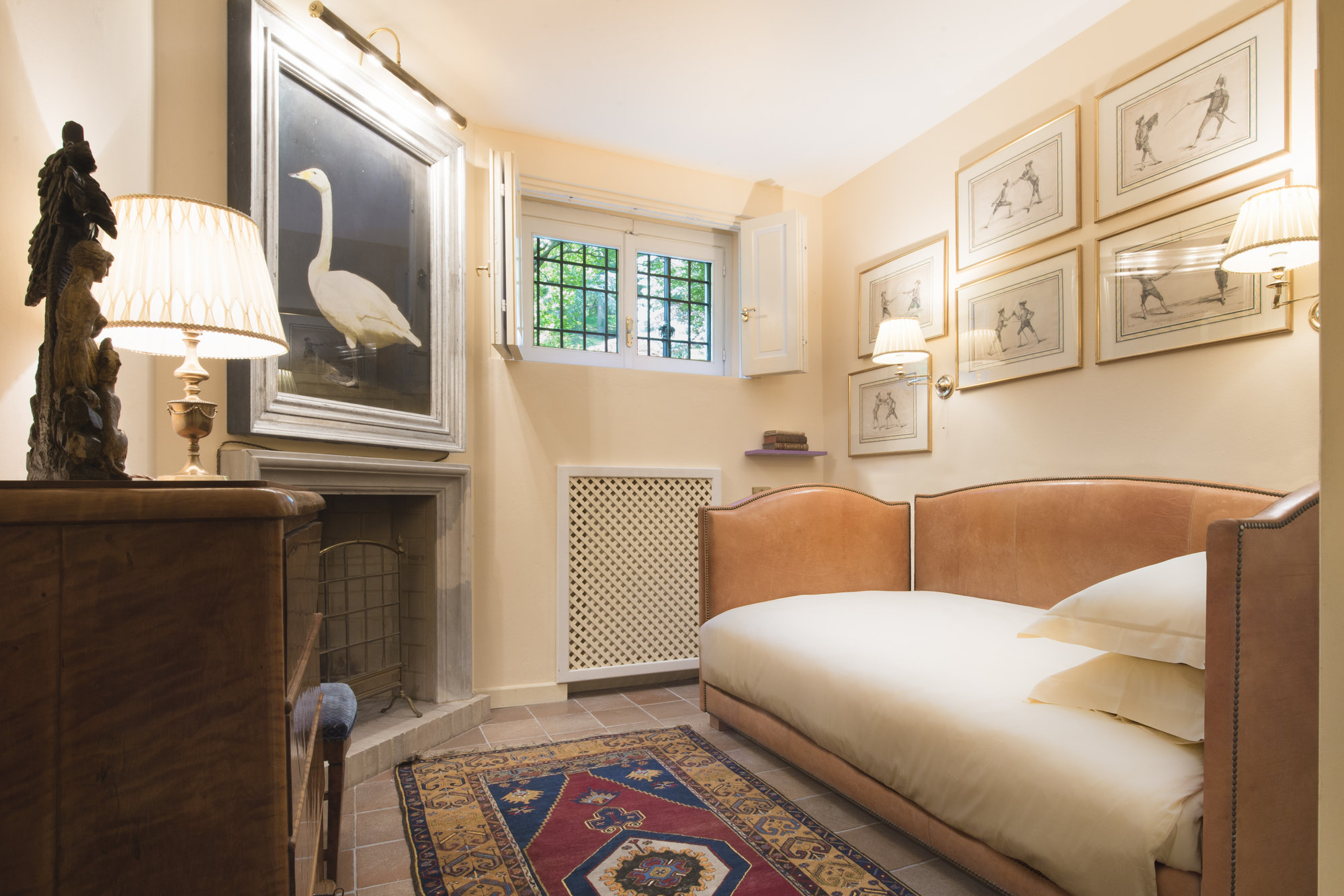 Snug bedroom with fireplace and fencing prints