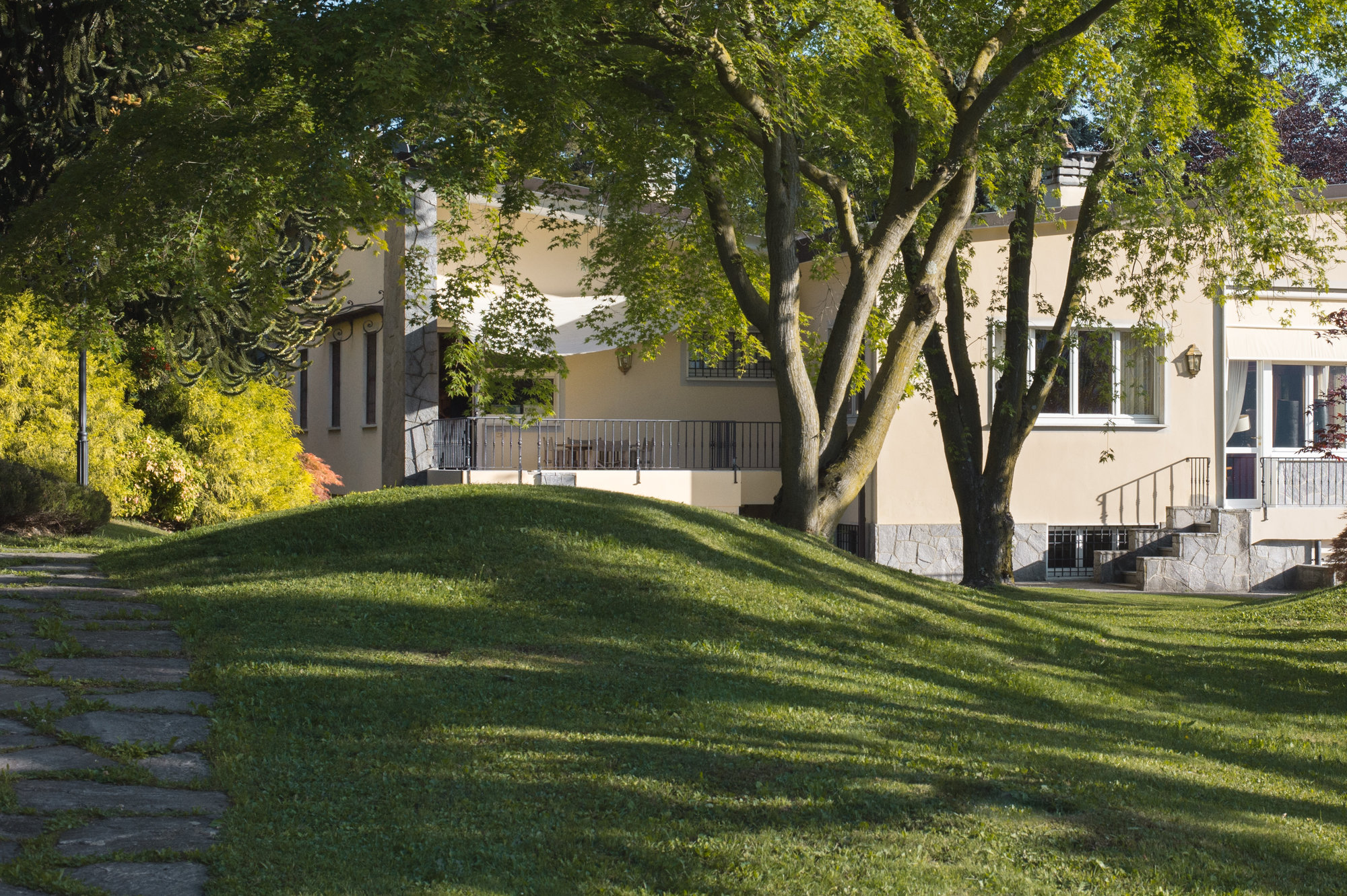 The villa seen across the lawn